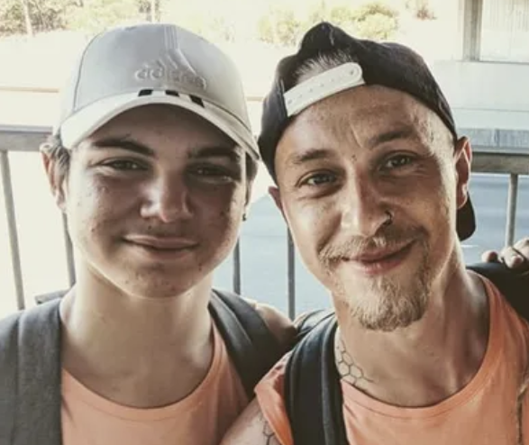 Scott and another man wearing hats looking at the camera